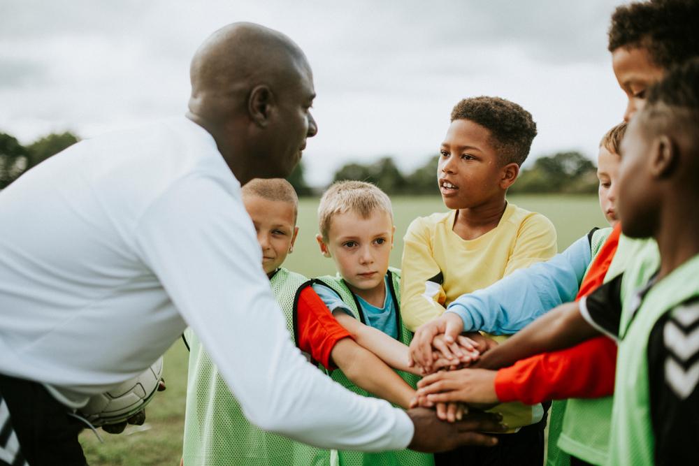 Coaches engaging with children in a community